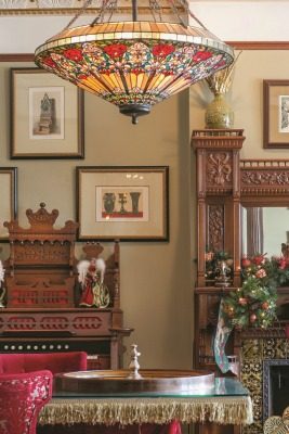 The game room is a fun place for guests to congregate. Just some of its highlights include a roulette wheel and the home’s original pump organ, as well as framed architectural drawings.