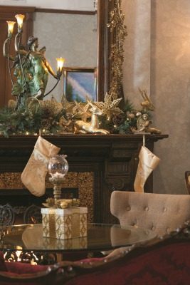 The music room with its grand piano, shimmers with gold holiday décor and candlelight. The light fixture on the mantle was originally thought to be just a figurine when Andrew spotted it at a Chicago auction.
