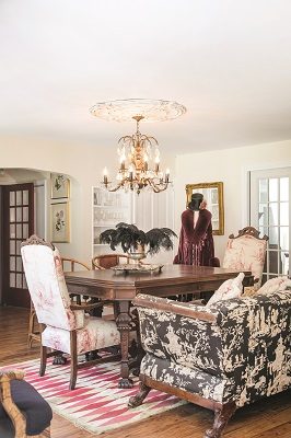 Plush seating takes center stage in the dining room. The 120-year-old high back chairs have been refreshed with new fabric, while the couch shows off its original Chinoiserie patterning. A dazzling 1920s chandelier, a find from Woodstock’s Interiors Anew, steals the show.