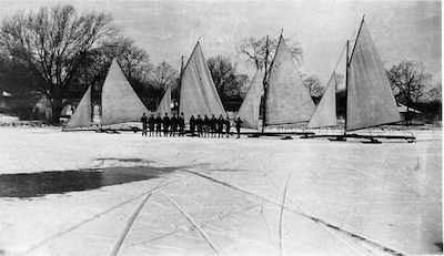  Boats from the 1920s and 1930s were designed as gaff-rigged, stern-steerers. All used an angled gaff spar (pole) on the hoist of the trapezoid-shaped sail. The Skeeters have a triangular sail and are hoisted to the top of the mast without this extra spar.
Photo credit: Williams Bay Historical Society