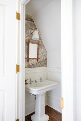 Off the turret room, a third-floor powder room features a pedestal sink that was salvaged from the original Glen Arden before the historic reconstruction.