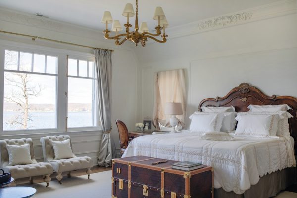 The primary bedroom, like all of the upstairs bedrooms, boasts stunning views of the lake.