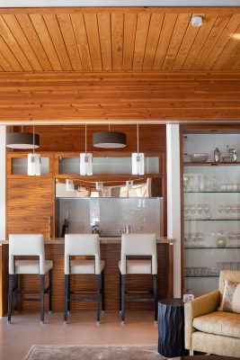 Custom cabinets and shelving crafted by a skilled artisan provide a seamless focal point in the home’s kitchen.