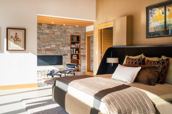 The home’s primary bedroom features a stone-clad reading nook with a gas fireplace.