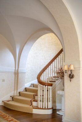 A sweeping staircase with hand-carved banisters led to the second-floor gallery of bedrooms.  Photo by Shanna Wolf