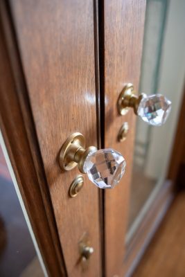 The home was finished with elegant details like these original crystal doorknobs.  Photo by Shanna Wolf